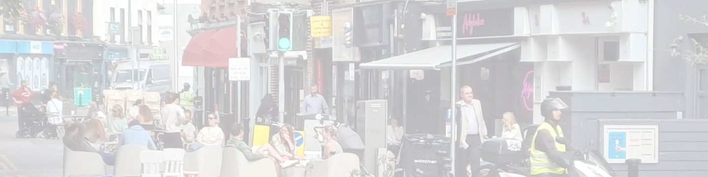 Photo looking northwest along the northeast side of Sandymount Green during summer weekend pedestrianisation showing people enjoying a vibrant environment on the street.