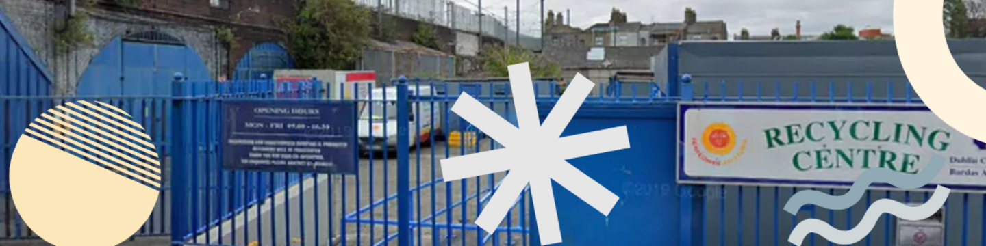 Entrance to a recycling centre with blue fencing and gates, viewed from street level. A sign reading “Recycling Centre” is visible on the right. Decorative coloured shapes overlay the top and bottom of the image.