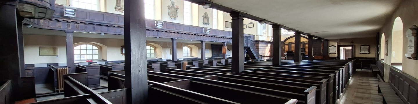 Image interior of Saint Werburgh's church with rows of wooden seat benches