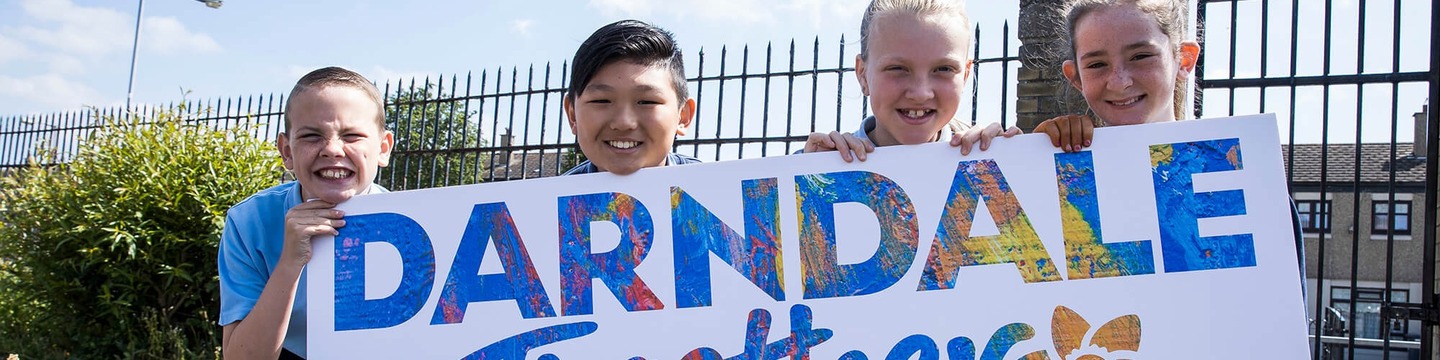 school children hold a darndale together sign in darndale