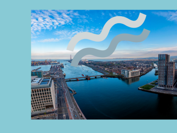 Aerial view of Dublin Docklands and the River Liffey on a clear day, showing modern waterfront buildings, bridges, and the city skyline. A large semi-transparent Dublin City Council logo overlays the centre of the image.