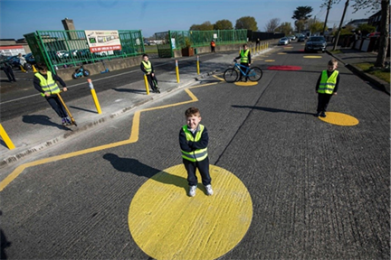 Title: Photo of colourful circular road markings at Scoil Fhursa. Cromcastle