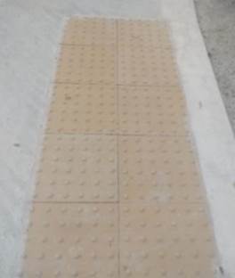 Photo of buff tactile blister paving at Scoil Neasáin, McAuley Road, Dublin 5.