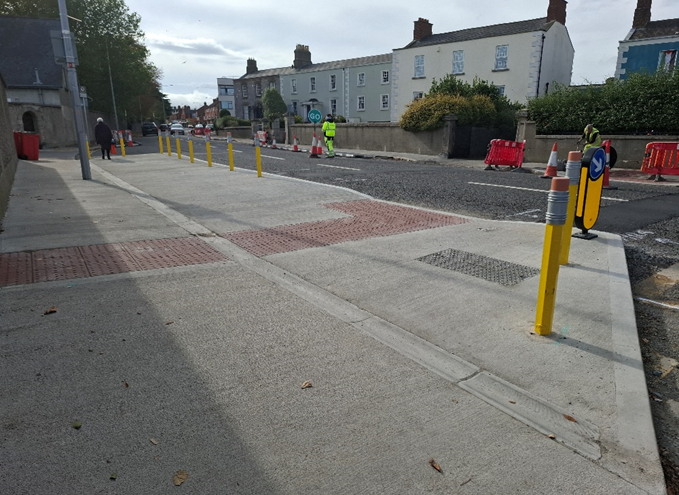 Photo of yellow pencil bollards on the footpath in Rathmines Road Upper.